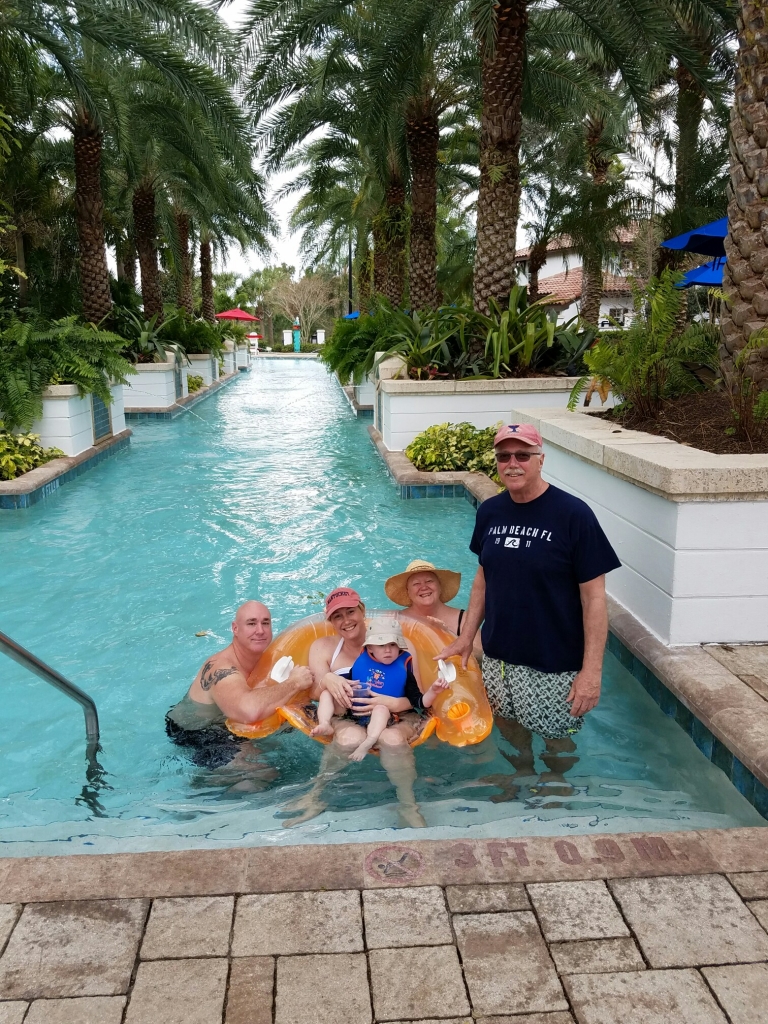 Grandparents with kids and grandchild in pool