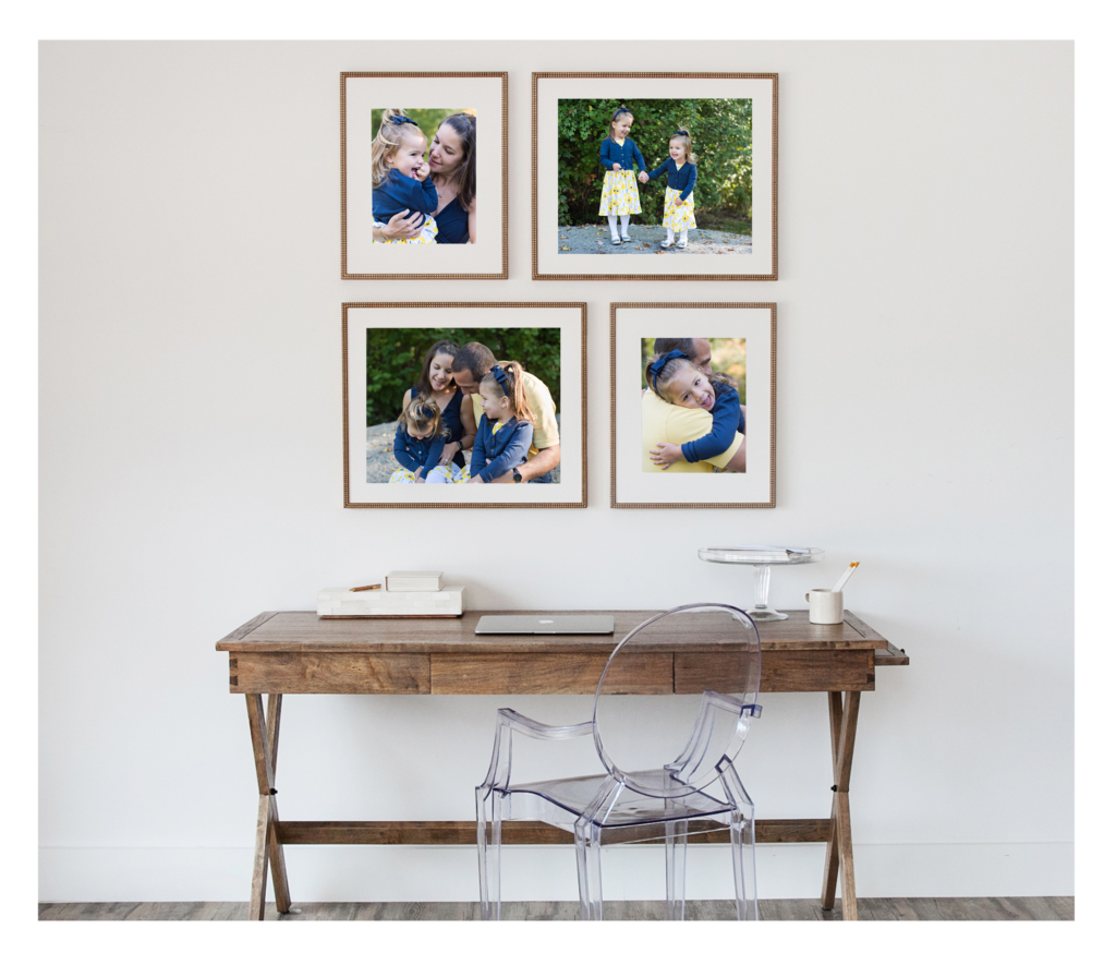 Four assorted framed photos above a desk