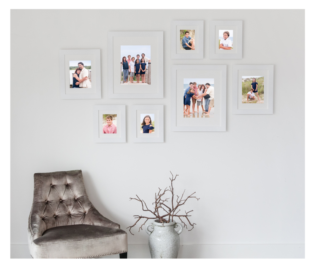Wall gallery of eight assorted framed photos above a chair